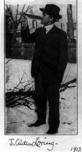 John Alden Loring, full-length portrait, standing, looking at a bird which has perched on his finger LCCN2005676615