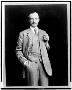 John Barry Ryan, three-quarter length portrait, standing, facing front, holding cigarette LCCN97520134
