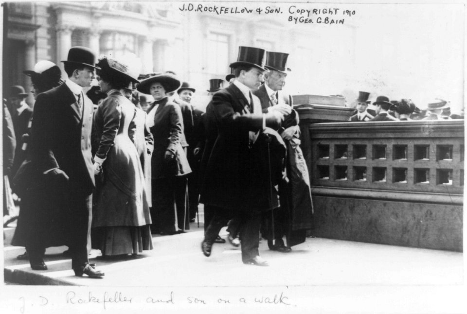 John Davison Rockefeller, full-length portrait, walking, facing right, with his son LCCN96508843