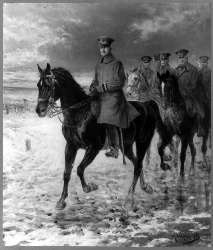 John Joseph Pershing, 1860-1948, full length, on horseback, facing left, followed by others on horseback, all in uniform LCCN2005689196