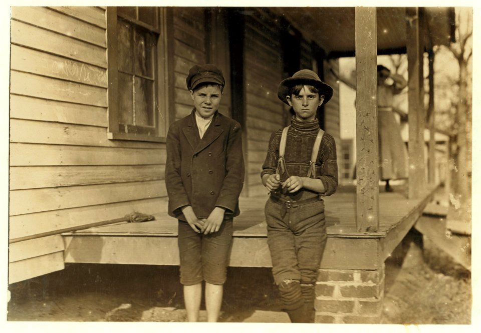 John Lewis (boy with hat) 12 years old. 1 year in mill. Weaver-4 looms. 40 cts. to start, 60 cents a day now. Brother and mother in mill. Morris Small (boy with cap) 'Reckon I been in mill 2 LOC nclc.01424