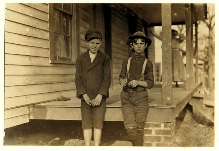 John Lewis (boy with hat) 12 years old. 1 year in mill. Weaver-4 looms. 40 cts. to start, 60 cents a day now. Brother and mother in mill. Morris Small (boy with cap) 'Reckon I been in mill 2 LOC nclc.01424