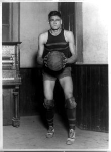 John Loebler, center on George Washington University basketball team, standing, full-length portrait, holding basketball LCCN96510358