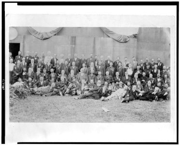 John M. Harlan seated in the center of a large group of men posed for a portrait LCCN95508059
