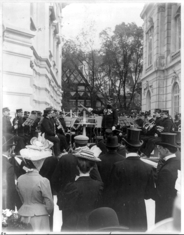 John Philip Sousa, 1854-1932, on podium in front of Marine Band, surrounded by Kodak fiends. LCCN2016650658