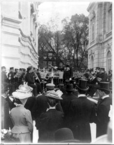 John Philip Sousa, 1854-1932, on podium in front of Marine Band, surrounded by Kodak fiends. LCCN2016650658