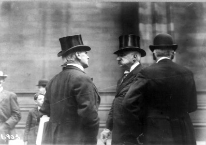 John Pierpont Morgan, half-length portrait, standing, facing left, with two friends, wearing top hat LCCN96508845