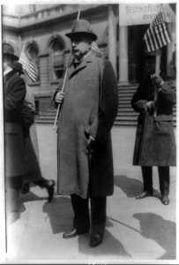 John Pierpont Morgan, Jr., full-length portrait, standing, facing left, holding U.S. flag LCCN90706914