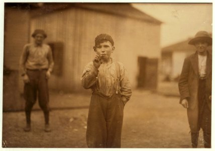 John Tidwell, a Cotton Mill Product. Doffer in Avondale Mills. Many of these youngsters smoke. LOC cph.3a01137