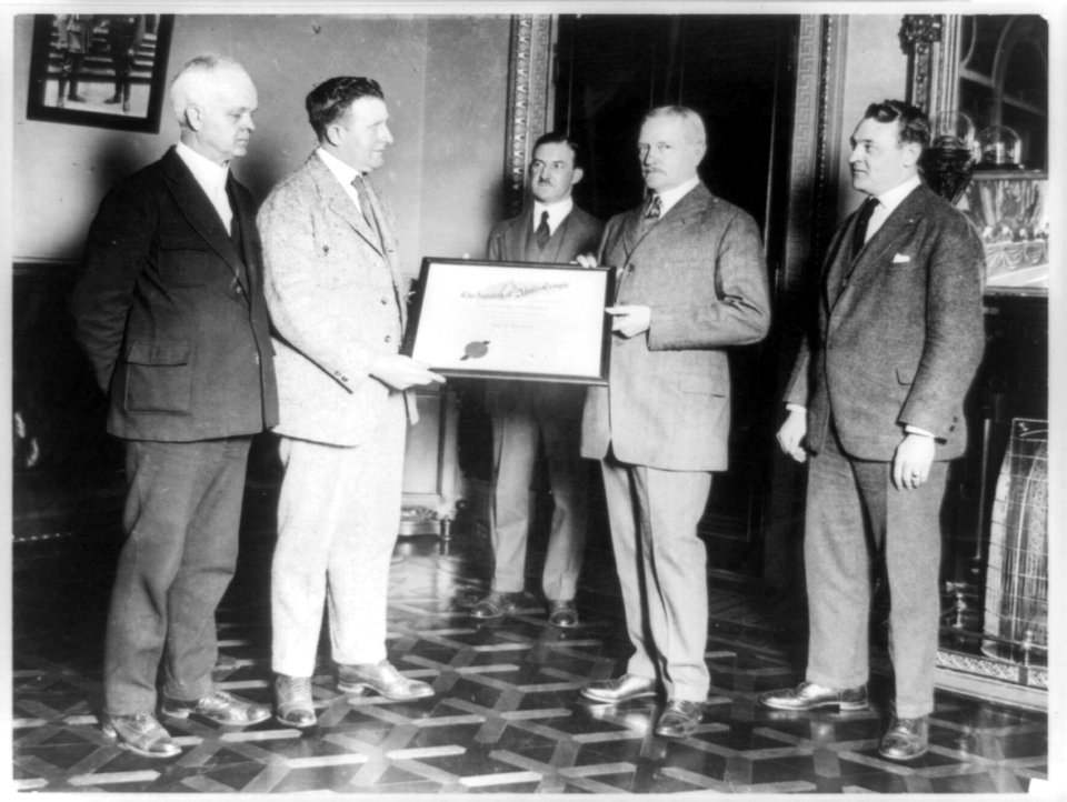 John J. Pershing and another man holding certificate of Nobility of Almas Temple, with three other men standing around them LCCN89709648