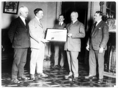 John J. Pershing and another man holding certificate of Nobility of Almas Temple, with three other men standing around them LCCN89709648