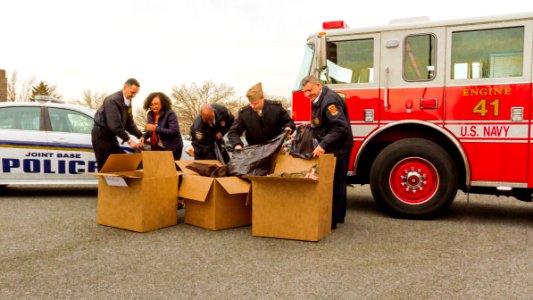 Joint base residents and workers donate coats to area residents in need 131220-N-WY366-001