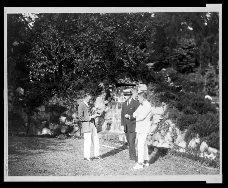 Joseph Lindon Smith, Albert Herter, and Evan Evans standing by the waterfall at the Rosemary Open-Air Theatre, Huntington, Long Island, site of the National Red Cross Pageant, Oct. 5, 1917 LCCN2005695723