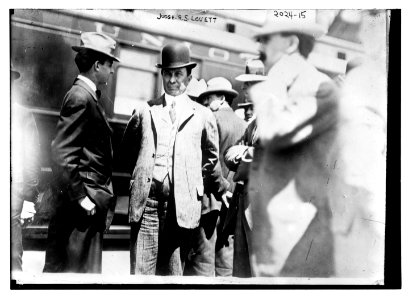 Judge R.S. Louett; Three-quarter view of Louett standing with a group of men in front of train LCCN2014688113
