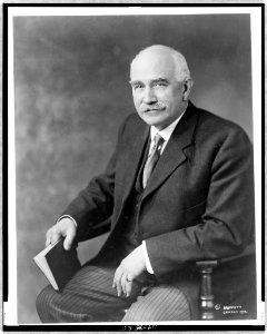 Judson Harmon, three-quarter length portrait, seated, facing left, holding book LCCN97518435