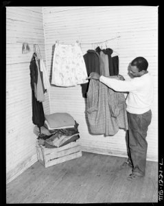 Julius Brooks, miner, in his four room house for which he pays $10 monthly, no closets or storage space is provided.... - NARA - 540740