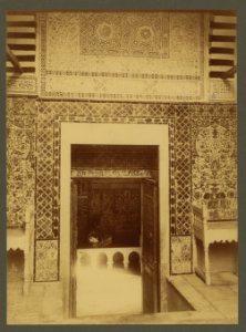 Kairouan. Doorway between two courtyards in the Mosque of the Barber, showing details of the Moorish tiles and fine bits of Arabic stucco work above the door which is chiselled out of hard LCCN2003690042