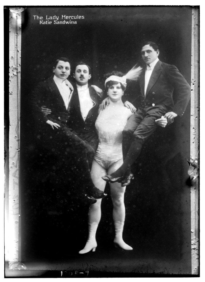 Katie Sandwina, the Lady Hercules (holding up three men) LCCN2014686831