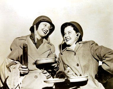 Kay Francis and Mitzi Mayfair pose in their traveling costumes after USO Camp Show overseas (34244884953)
