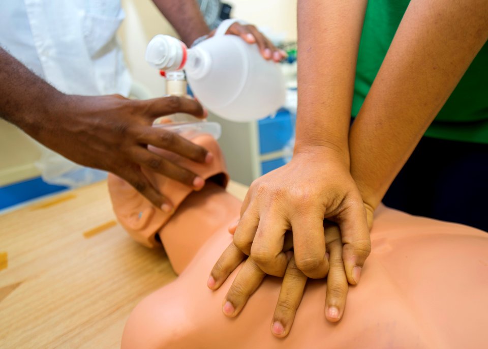 Kevin Dawson, a rural health nurse, and Lissette Recinos, a public health nurse, conduct a subject matter expert exchange on advanced cardiac life support with U.S. Navy Lt. Cmdr. Suzanne Maldarelli, a medical 140627-N-XQ474-063