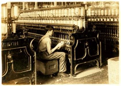 King Philip Spinning room. Oiler Boy - Oils all the spindles in this room. George Courtemonds, 114 Kellogg St. October 3, 1915, 14 years old. LOC cph.3b33431