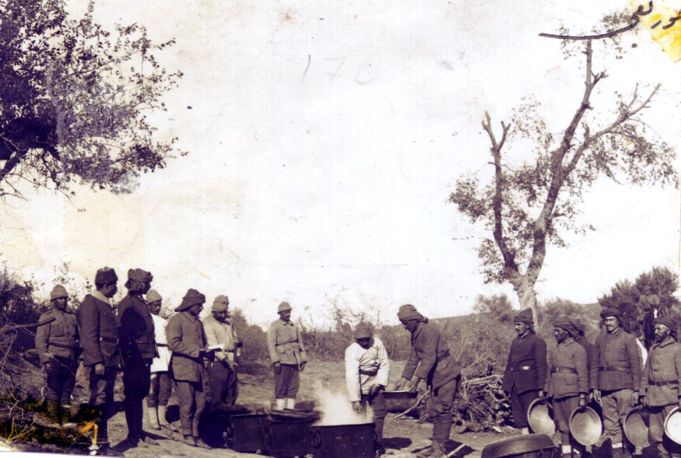 Kitchen crew distributing the food to soldiers