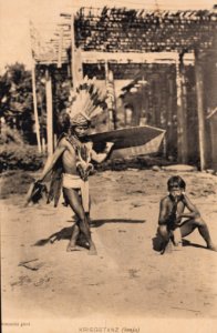 KITLV - 174175 - Demmeni, J. - Kenyah sword dancer accompanied by a kledi player (mouth organ) in Apo Kayan in East Borneo - 1895-1900