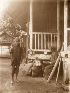 KITLV - 158783 - Kurkdjian - Sourabaia-Java - Priest (Walian) and a woman in a village in the Minahasa - circa 1900