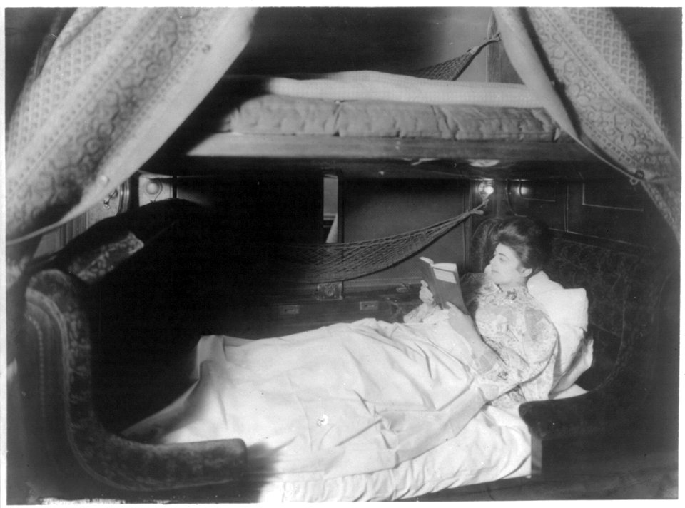Lady reading in berth with curtains down LCCN2012649451