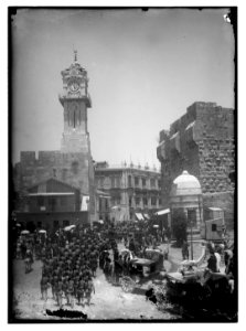 Marching in front of Am. (i.e., American) Colony store. Grand New Hotel (Jerusalem) LOC matpc.06380
