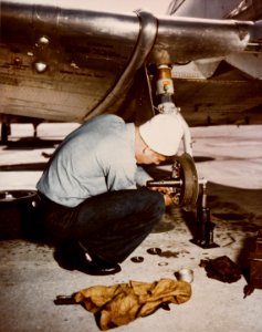 Landing gear repair on a North American SNJ at Naval Air Station Norfolk on 20 April 1945 (80-G-K-4632) photo