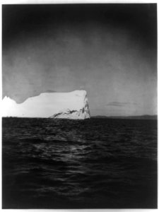 Large iceberg in the Atlantic Ocean, off the coast of Labrador, with land visible on the horizon LCCN2012645590