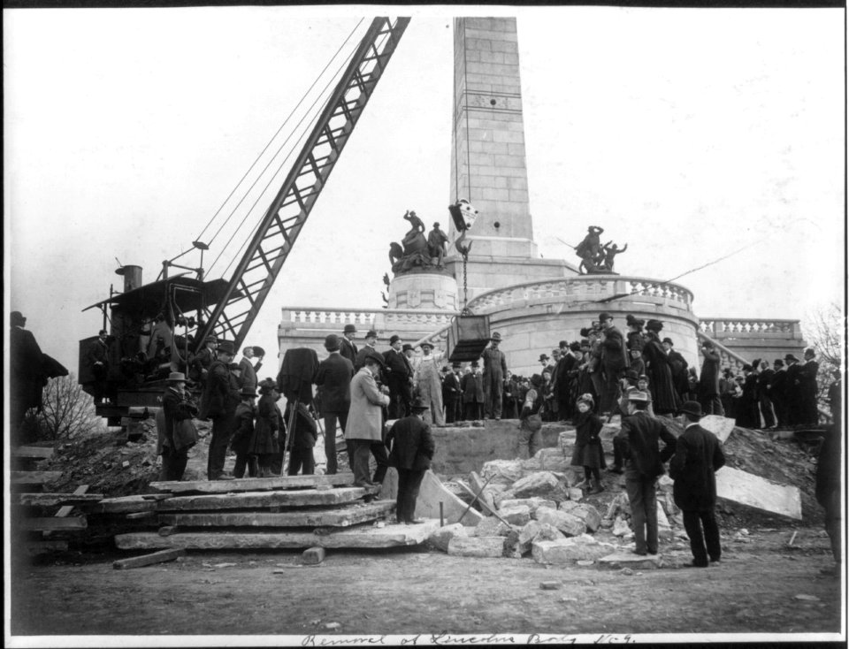 Large crowd watching crane lift box containing Abraham Lincoln's body above grave in front of Lincoln Memorial at Springfield, Ill. LCCN2005684967