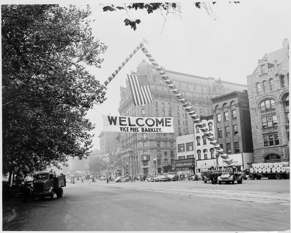 Large sign hung above Pennsylvania Ave., near the Willard Hotel, saying, Welcome Vice Pres. Barkley. President... - NARA - 199954