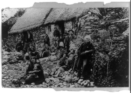 Large group of Irish peasants in front of thatch-roofed house LCCN2017656337 photo