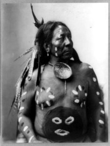 Last Horse, half-length portrait, facing right; wearing body paint and feathers in his hair LCCN92509848