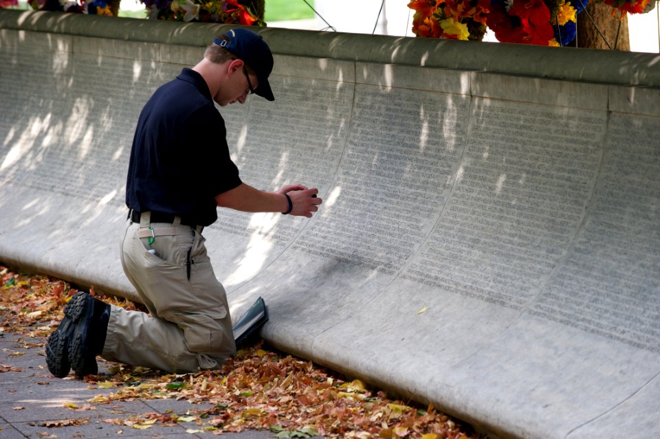 Law enforcement explorer traces names at the National Law Enforcement Officers Memorial