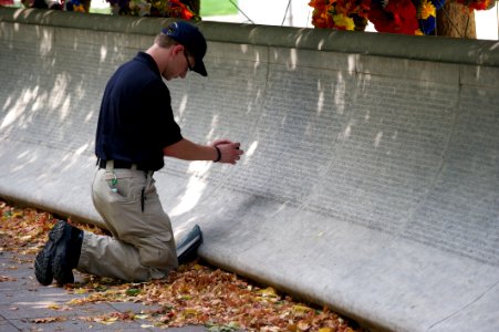 Law enforcement explorer traces names at the National Law Enforcement Officers Memorial photo