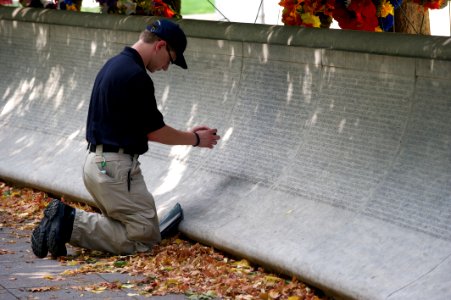Law enforcement explorer traces names at the National Law Enforcement Officers Memorial