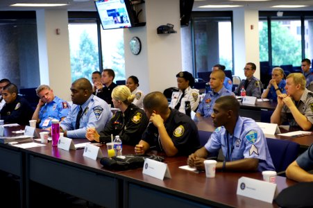 Law Enforcement Explorers from various agencies sit together photo