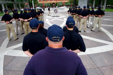 Law enforcement explorers stand in formation observing wreath photo