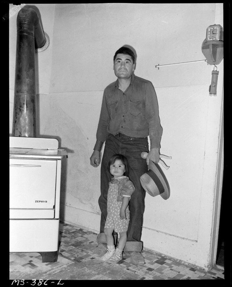 Lawrence Trujillo, miner and his daughter in their home in company housing project. Colorado Fuel & Iron Corporation... - NARA - 540385
