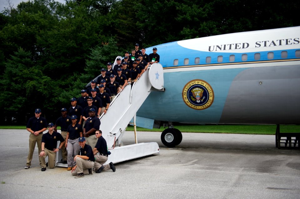 Law enforcement explorers aboard stairs to plane