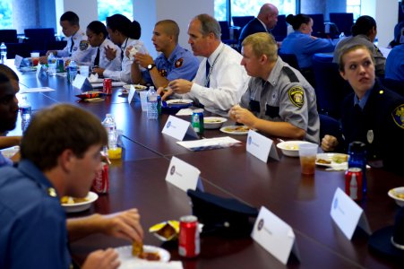 Law enforcement explorers from various agencies seated around a table together photo