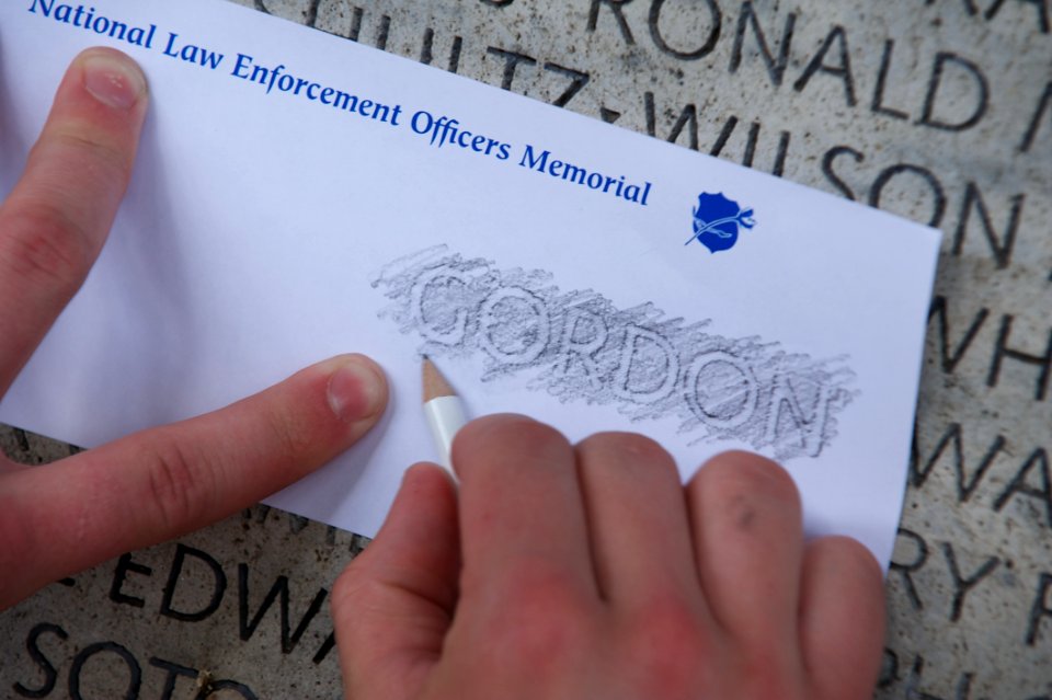 Law enforcement explorer traces names at the National Law Enforcement Officers Memorial 2