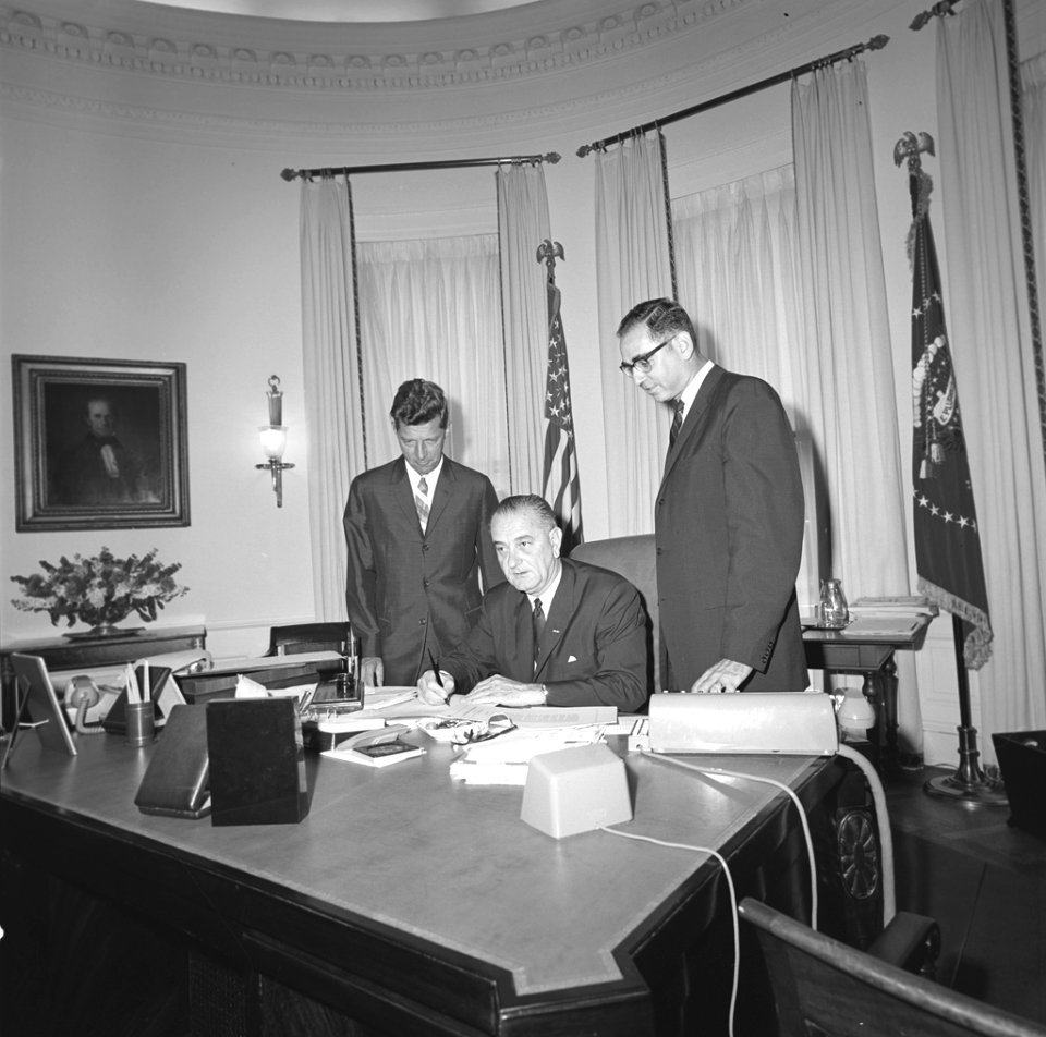 LBJ signs bill in the Oval Office 1964