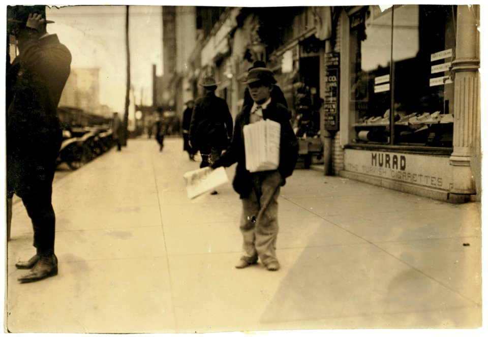 Leroy Raley, 215 Noble St., a 10-year-old truant newsboy, who was photographed during school hours. Said- 'Someone stole my clothes so I couldn't go to school.' LOC nclc.04025