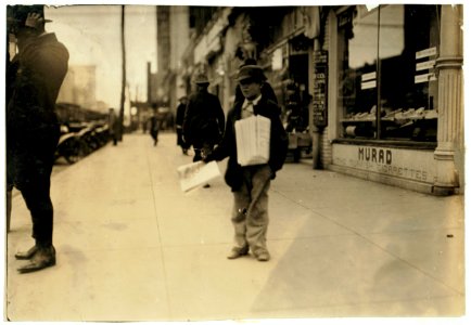 Leroy Raley, 215 Noble St., a 10-year-old truant newsboy, who was photographed during school hours. Said- 'Someone stole my clothes so I couldn't go to school.' LOC nclc.04025