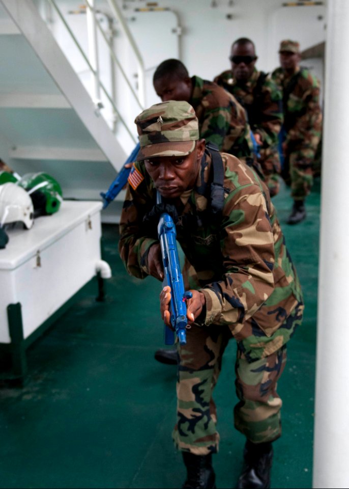 Liberian service members practice room clearing and tactical movement techniques aboard the Spanish Civil Guard patrol ship Rio Segura March 8, 2014, in Dakar, Senegal, during exercise Saharan Express 2014 140308-N-QY759-077