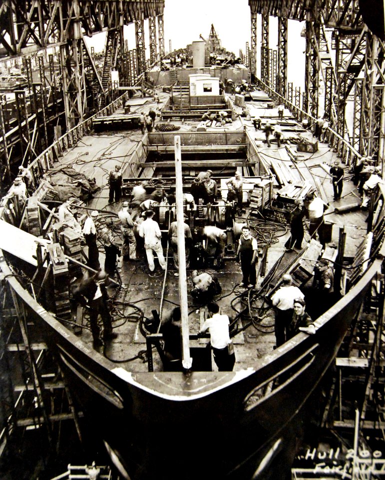 Liberty Ship hull being cleaned up for launching ceremony, WWII (26248526764)